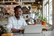 © Jelena - Casual portrait of a man working remotely in a chic urban cafe Blending work and lifestyle