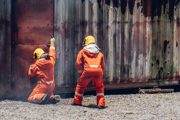 Wall Mural - First aid support accident at work. Firefighter to save girl in fire and smoke. Rescue Team or Firefighters save lives people from fire. Firefighter or Emergency team rescue saving life people