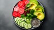 Top view of assorted fresh vegetables and fruits arranged on plate as ingredients for cooking dish sliced cucumbers lime and radish pieces of avocado and chia seeds on gray background