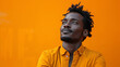 Portrait of a confused puzzled minded African American man in orange top isolated on orange background,