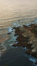 Rugged Shore With Houses Built Among The Trees. Lovely Coastline Of Pacific Ocean With Waves Splashing By. Sunset By The Ocean. Vertical Video.