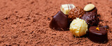 Fototapeta Kwiaty - chocolate pralines on chocolate background