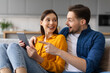 © Prostock-studio - Excited couple with digital tablet, man pointing at screen