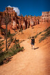 © Denis Comeau - Middle-aged woman hiking the Queen’s Garden Trail in Bryce Canyon National Park, Utah.
