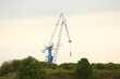 View of cranes in port at evening time