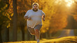Funny overweight man jogging on the road