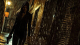 Fototapeta Do pokoju - Young woman in black clothes walks with gun in rain, mercenary or killer holding weapon on dark alley. Female person and pistol at night. Concept of spy, movie, murderer, people.