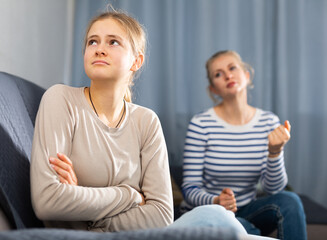 Wall Mural - Mother soothes teen daughter after an quarrel at home