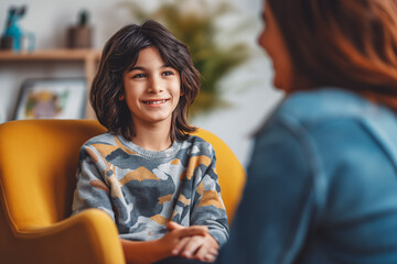 Wall Mural - Therapist, psychology and boy on a chair, talking and child development with a smile.