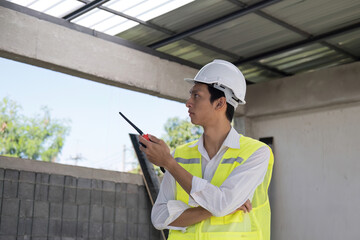 Civil engineer teams meeting working together wear worker helmets hardhat on construction site in modern city. Foreman industry project manager engineer teamwork. Asian industry professional team