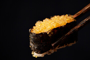 Poster - Seaweed rolled flying fish roe sushi on chopsticks