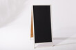 A blank sandwich board sign stands ready for customization or advertising, with copy space
