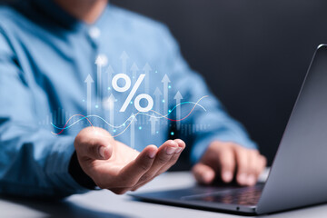 Interest rate and dividend concept. business financial investment, business growth, income, marketing and profit. Person hold up arrow icon and percentage with graph indicators for investment growth.