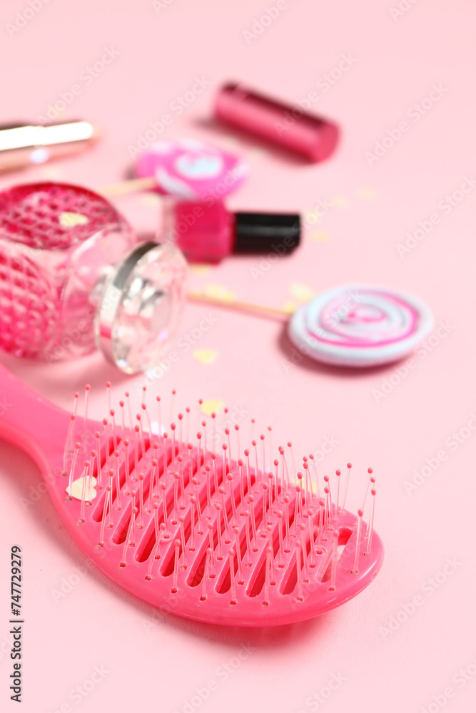 Decorative cosmetics and hair brush on pink background, closeup. Valentine's Day celebration