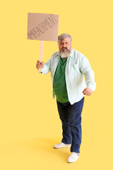 Wall Mural - Protesting mature man holding placard with word IMPEACHMENT on yellow background