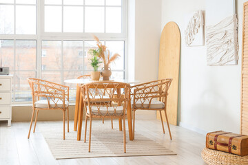 Interior of light room with dining table and 3D paintings