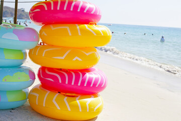 Wall Mural - Inflatable rings on the beach. Summer concept