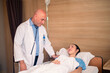 © Suriyo - Doctor checking treatment patient on bed in hospital. Doctor treatment healthcare concept.
