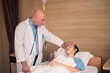 © Suriyo - Doctor checking treatment patient on bed in hospital. Doctor treatment healthcare concept.