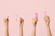 © Pixel-Shot - Female hands with cuticle oil pen, nail cutter and brush on pink background