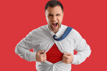 Poster - Angry superhero businessman tearing his shirt on red background