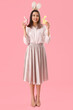 © Pixel-Shot - Beautiful young woman in bunny ears with toys rabbit on pink background. Easter celebration