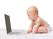 © T. Rose/peopleimages.com - Baby, laptop and studio for entertainment, fun and games in child development and online technology. Kid, happy and newborn for home, diaper and white background for playful and watch screen