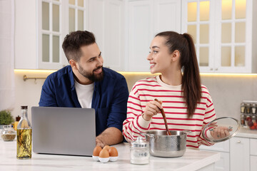 Sticker - Happy lovely couple using laptop while cooking in kitchen