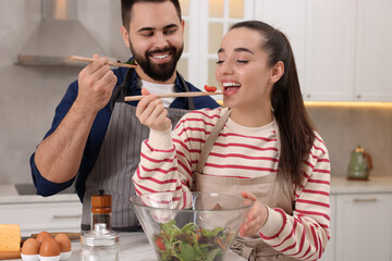 Wall Mural - Happy lovely couple cooking together in kitchen