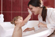 © New Africa - Happy mother with her little daughter spending time together in bathroom