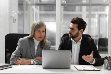 Canvas Print - Lawyers working together at table in office