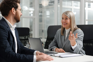 Canvas Print - Lawyer working with client at table in office