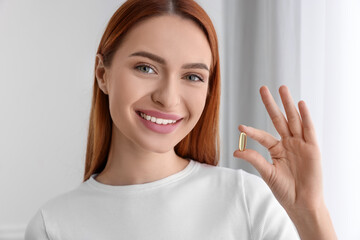 Poster - Beautiful young woman with vitamin pill at home