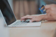 © ART STOCK CREATIVE - Close Up man hands holding credit card using online shopping with laptop, Online payment at home or office, internet banking, future lifestyle ideas for spending or entrepreneurs in ordering products