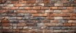 © Lasvu - A sturdy brick wall constructed using red and gray bricks, showcasing the texture and material used in industrial construction. The wall provides a strong and durable foundation for the structure.