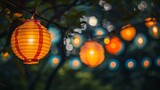 Fototapeta  - A beautiful image of a string of glowing paper lanterns hanging from a tree in a garden at night.