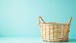 This is a photo of an empty wicker basket on a blue background. The basket is made of natural wicker and has a round shape with two handles.