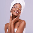 © MV/peopleimages.com - Hands, face and black woman with eyes closed for beauty, cosmetics and spa treatment on purple background. Skincare glow, dermatology and self care with happy African model touching skin in studio