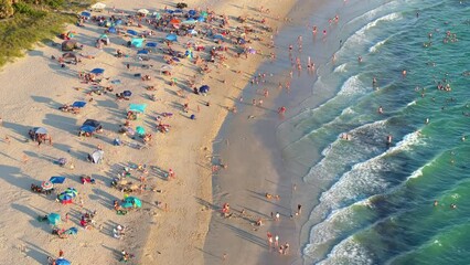 Wall Mural - High angle view of crowded Nokomis beach in Sarasota County, USA. Many people enjoying vacations time swimming in ocean water and relaxing on warm Florida sun at sundown