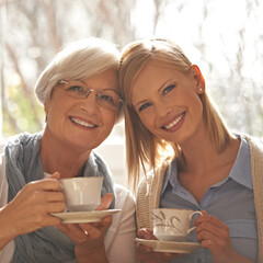 Sticker - Portrait, smile and woman with senior mother drinking coffee at breakfast in the morning, bonding and happy in house. Face, elderly mom and daughter with tea cup, love and family at home together