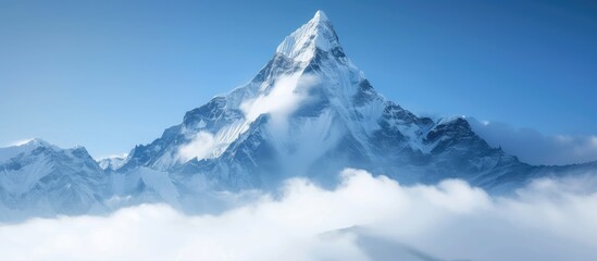 Poster - A snow-covered mountain peak towering over the clouds below. The foggy foreground adds to the dramatic scene of natures power and beauty.