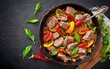 Fried chicken liver with apples and sweet peppers in iron skillet