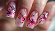 Close-up of Manicured Nails with Flowers and Rhinestones