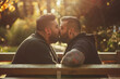 Male couple tenderly kissing in a park