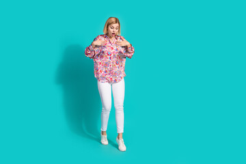 Sticker - Full size photo of astonished girl wear oversize shirt white trousers look down at empty space isolated on turquoise color background