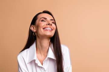 Wall Mural - Portrait of stunning peaceful cheerful elegant lady beaming smile closed eyes empty space isolated on beige color background