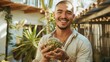 Smiling man with tattoos holding a large artichoke.