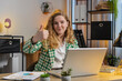 © Andrii Iemelianenko - Like. Smiling Caucasian businesswoman looking approvingly at camera showing double thumbs up sign positive something good great news positive feedback. Happy girl using laptop at home office desk.