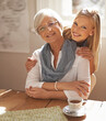 © MV/peopleimages.com - Senior woman, daughter and portrait in lounge with tea for hug, visit and retirement. Elderly pensioner, grandmother and lady with smile in home for affection together with love and gesture of touch