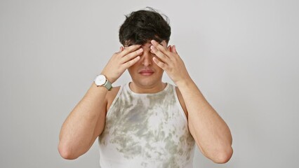 Wall Mural - Young man, stressed and worn-out, rubbing tired eyes due to fatigue. sleepy expression echoes headache and vision problems. isolated against white background.